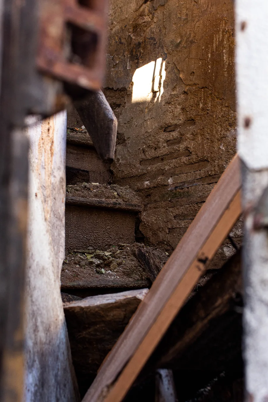 Dark interior stairwell corner with a beam of light