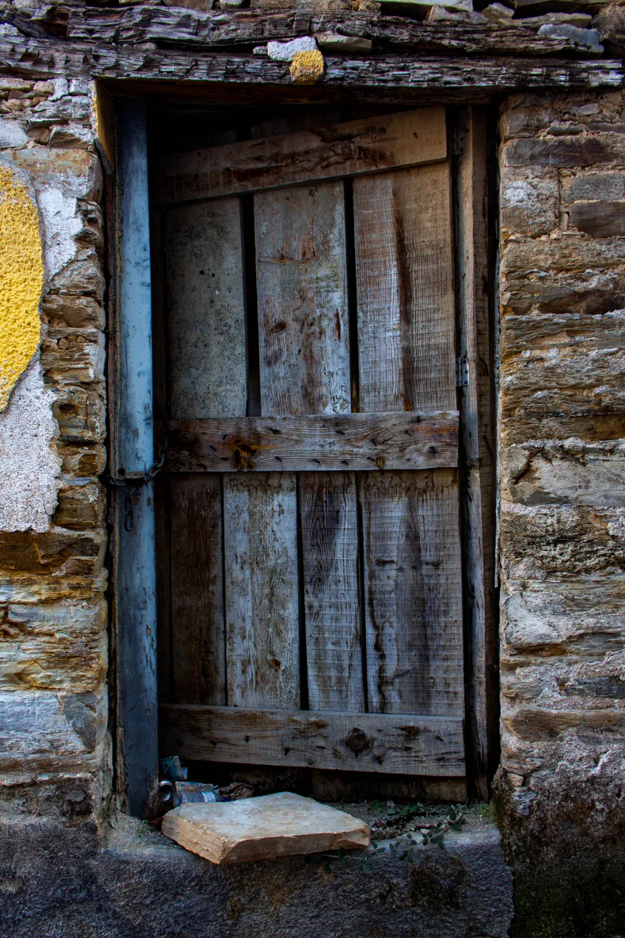 Rustic wooden door set in a stone frame, symmetrical